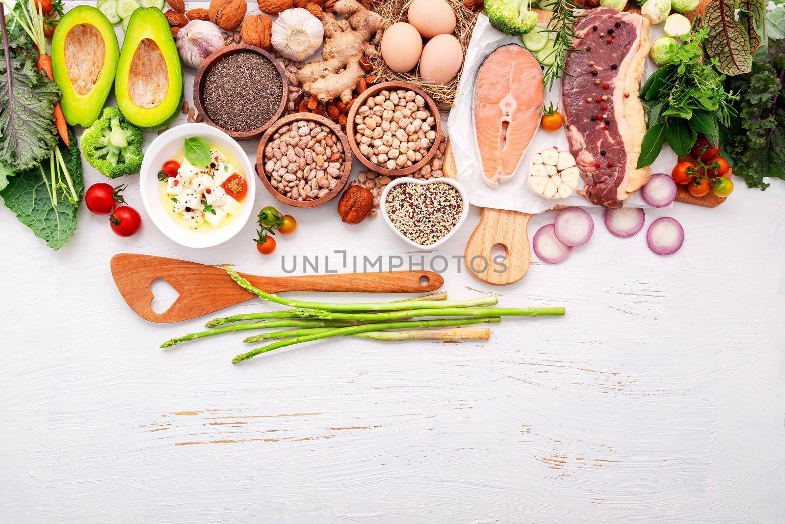 Ketogenic low carbs diet concept. Ingredients for healthy foods selection set up on white wooden background. by kerdkanno