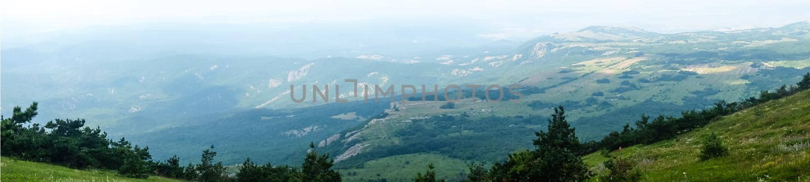 A view of the mountains covered with dense forest from the upper plateau of the Chatyr-Dag mountain range in Crimea. Panorama