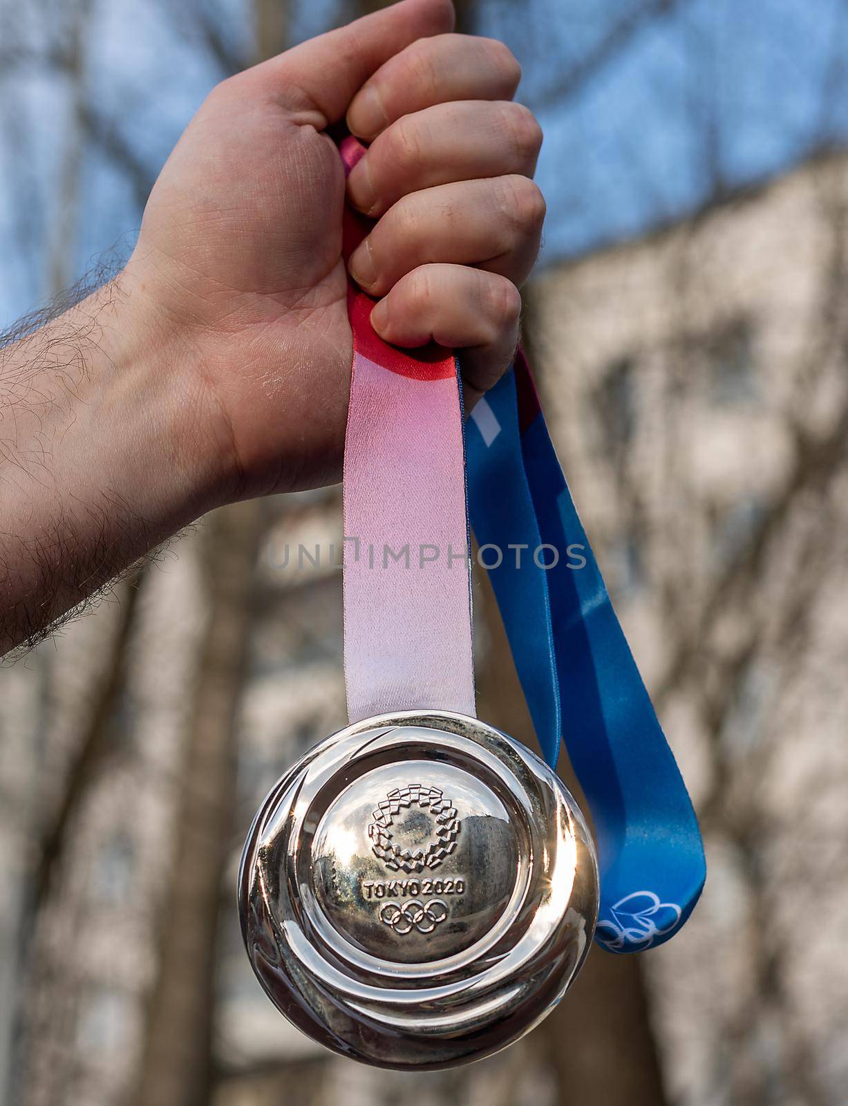 April 17, 2021 Tokyo, Japan. Silver medal of the XXXII Summer Olympic Games in Tokyo in the hand of an athlete.
