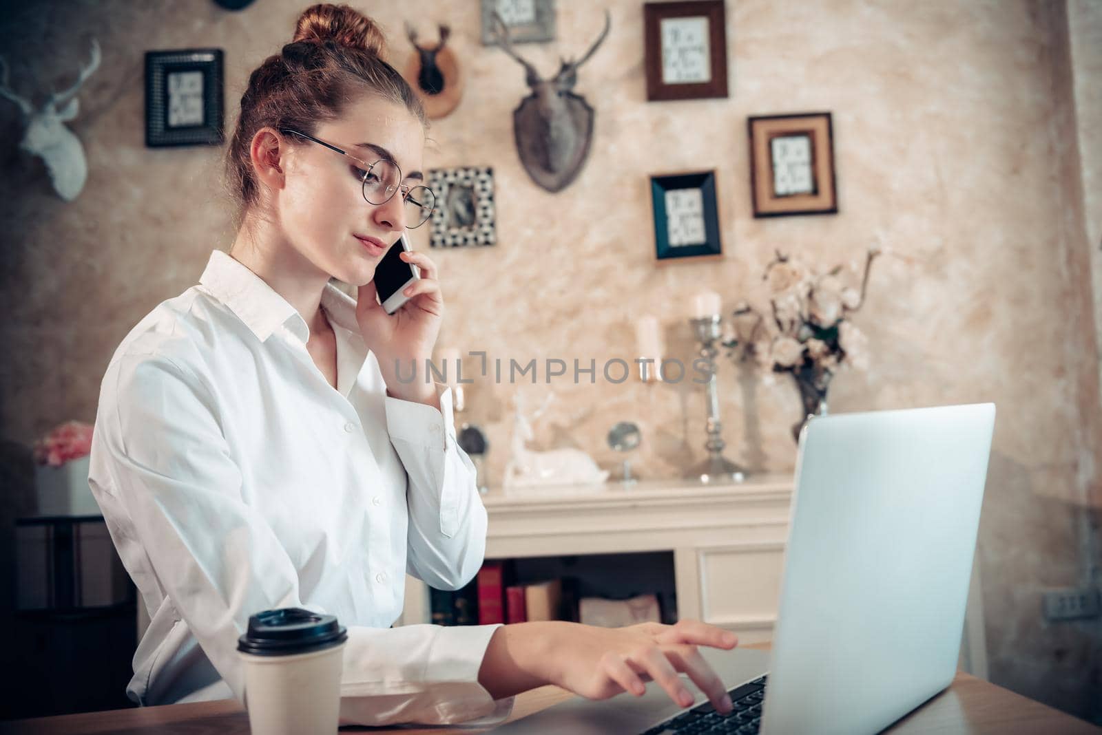 Business Entrepreneur Woman is Working on Table Desk While Calling on Mobile Phone for Own Business in Her Home Office, Businesswoman Worker Busy Work at Home During Covid-19 Pandemic. by MahaHeang245789