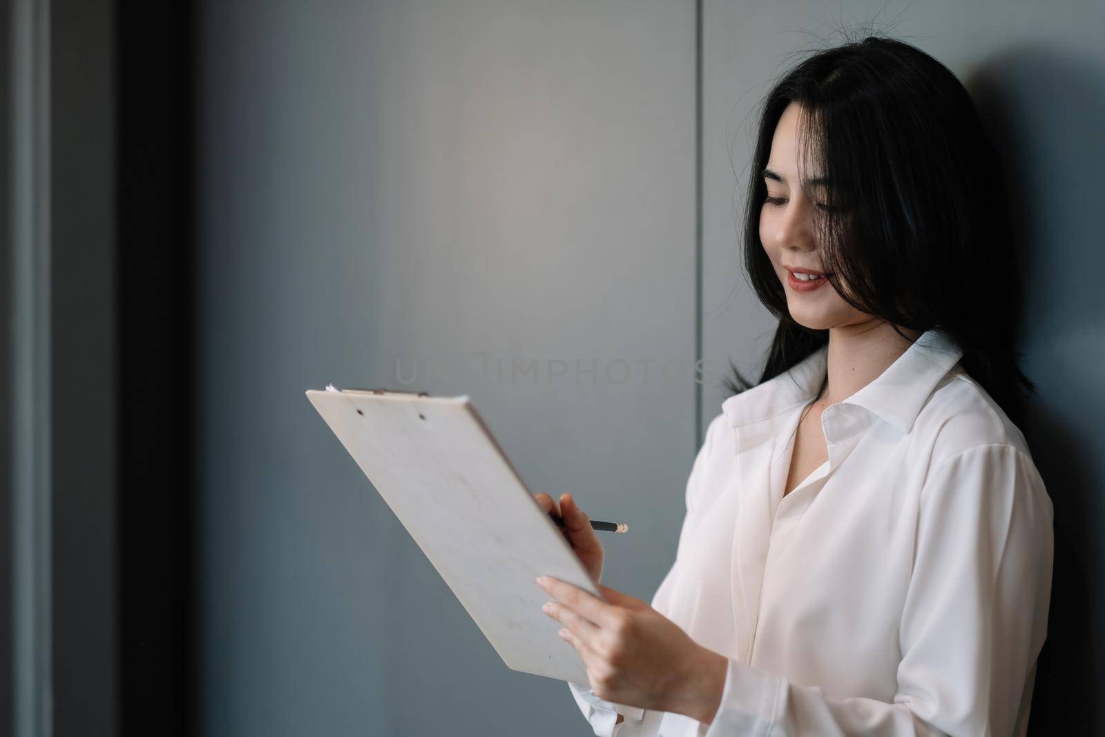 Portrait of Financial businesswoman analyze the graph of the company's performance to create profits and growth, Market research reports and income statistics, Financial and Accounting concept.