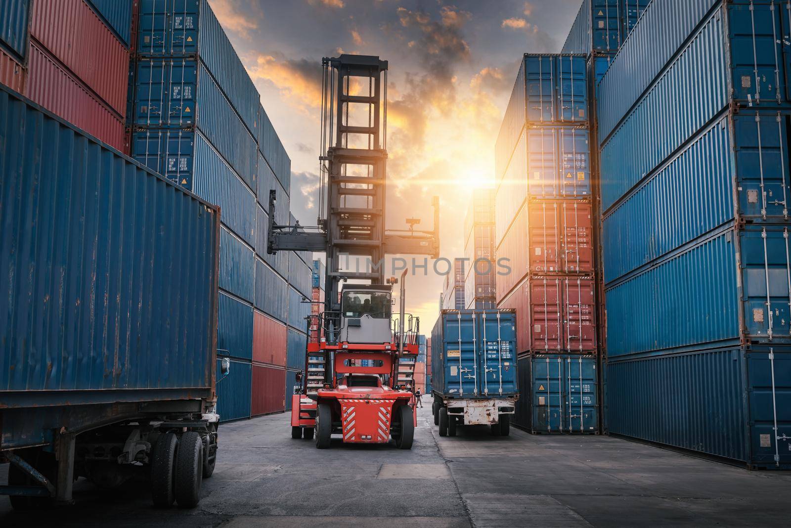 Container Ship Loading of Import/Export Freight Transportation Industry, Transport Crane Forklift is Lifting Box Containers at Port Cargo Shipping Dock Yard. Logistic Freighting Ship Service 