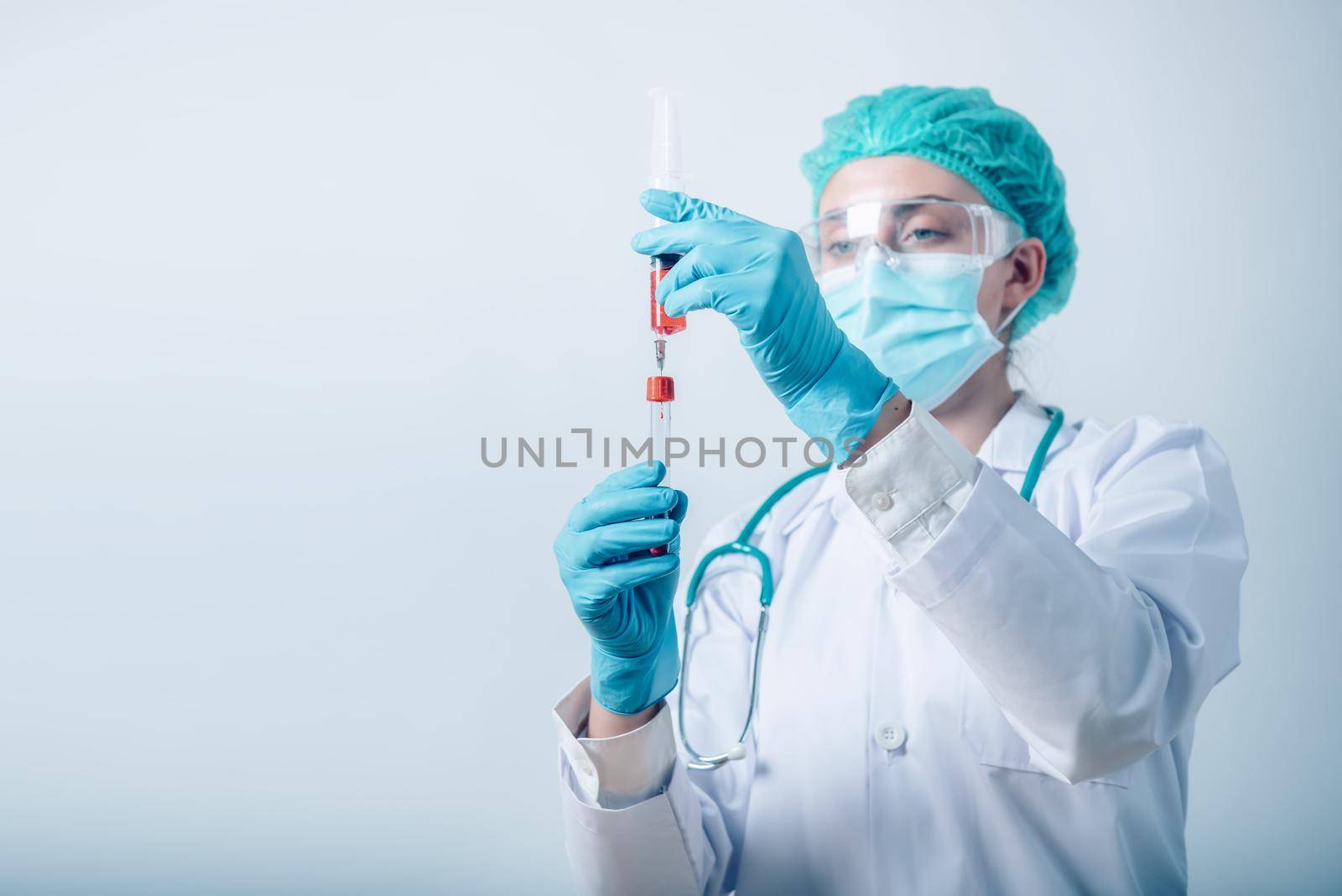 Lab Scientist Woman is Working in Scientific Chemical Laboratory, Female Medicine Science is Injecting Blood Syringe into Sample Tube for Experiment Biology in Clinic Laboratory. Healthcare/Medical