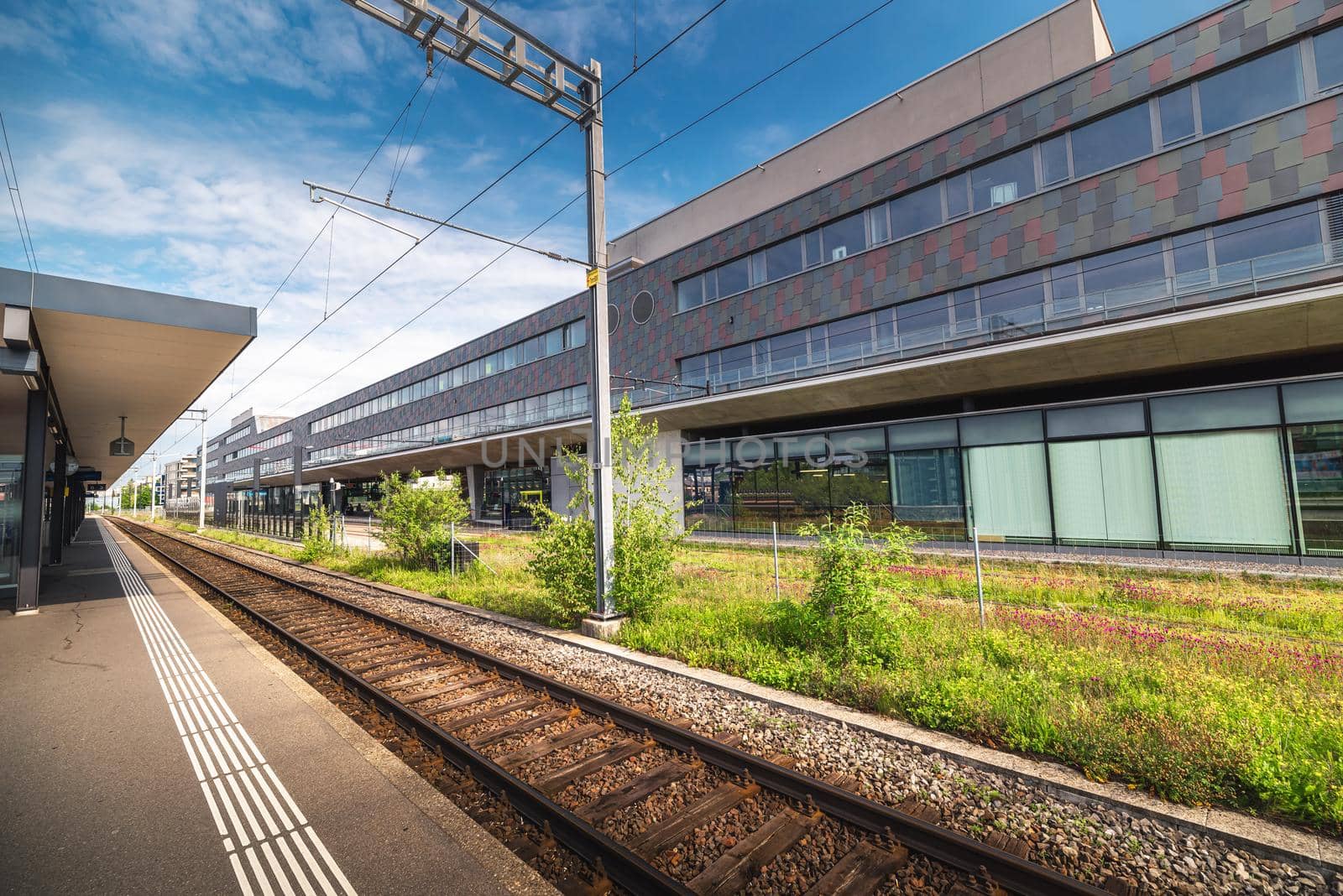 Train Station Platform in Urban Zurich City, Switzerland, Public Metro Transit and Infrastructure of Swiss Trains. Perspective View of Railway and Modern Architecture Building Background. Swiss Travel