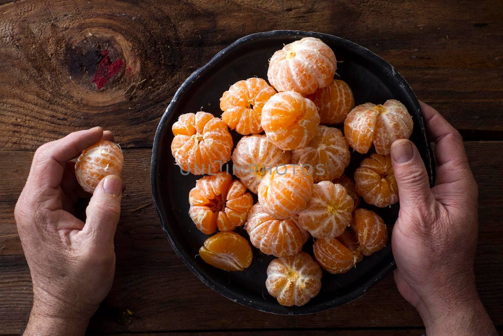 Presentation of Small peeled mandarin oranges on old wooden table