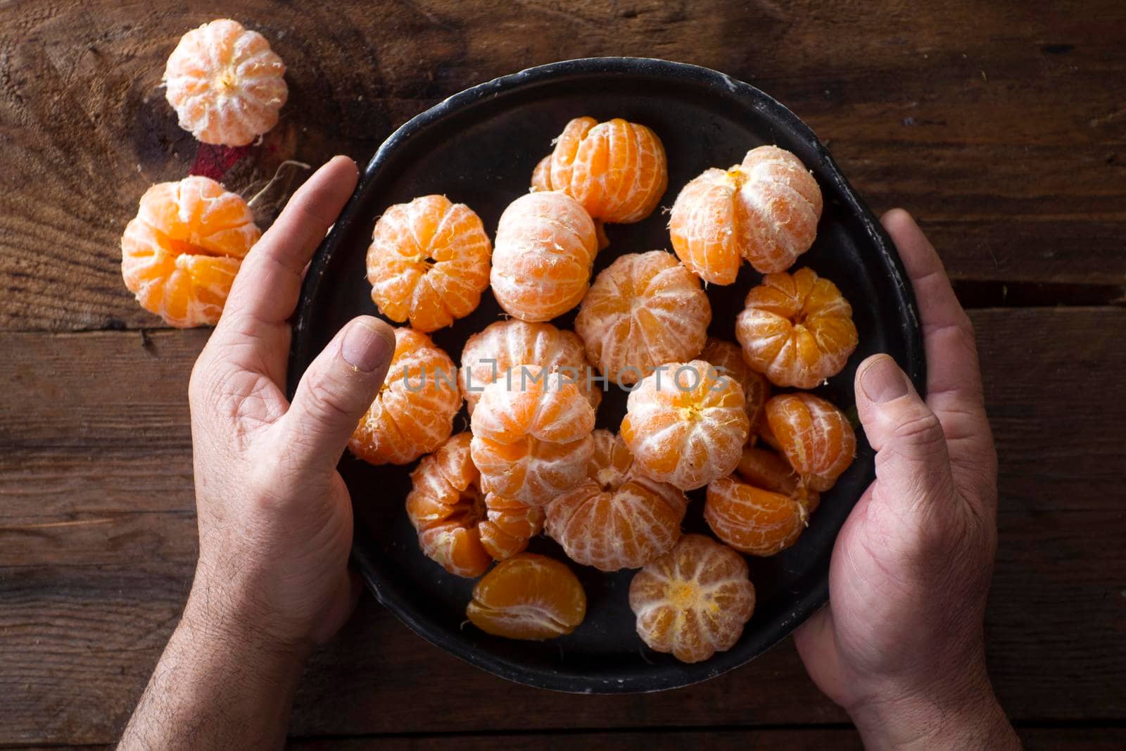 Presentation of Small peeled mandarin oranges on old wooden table