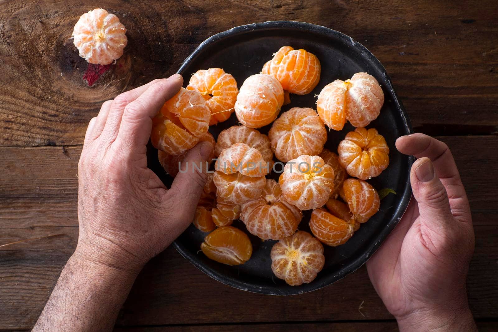 Presentation of Small peeled mandarin oranges on old wooden table