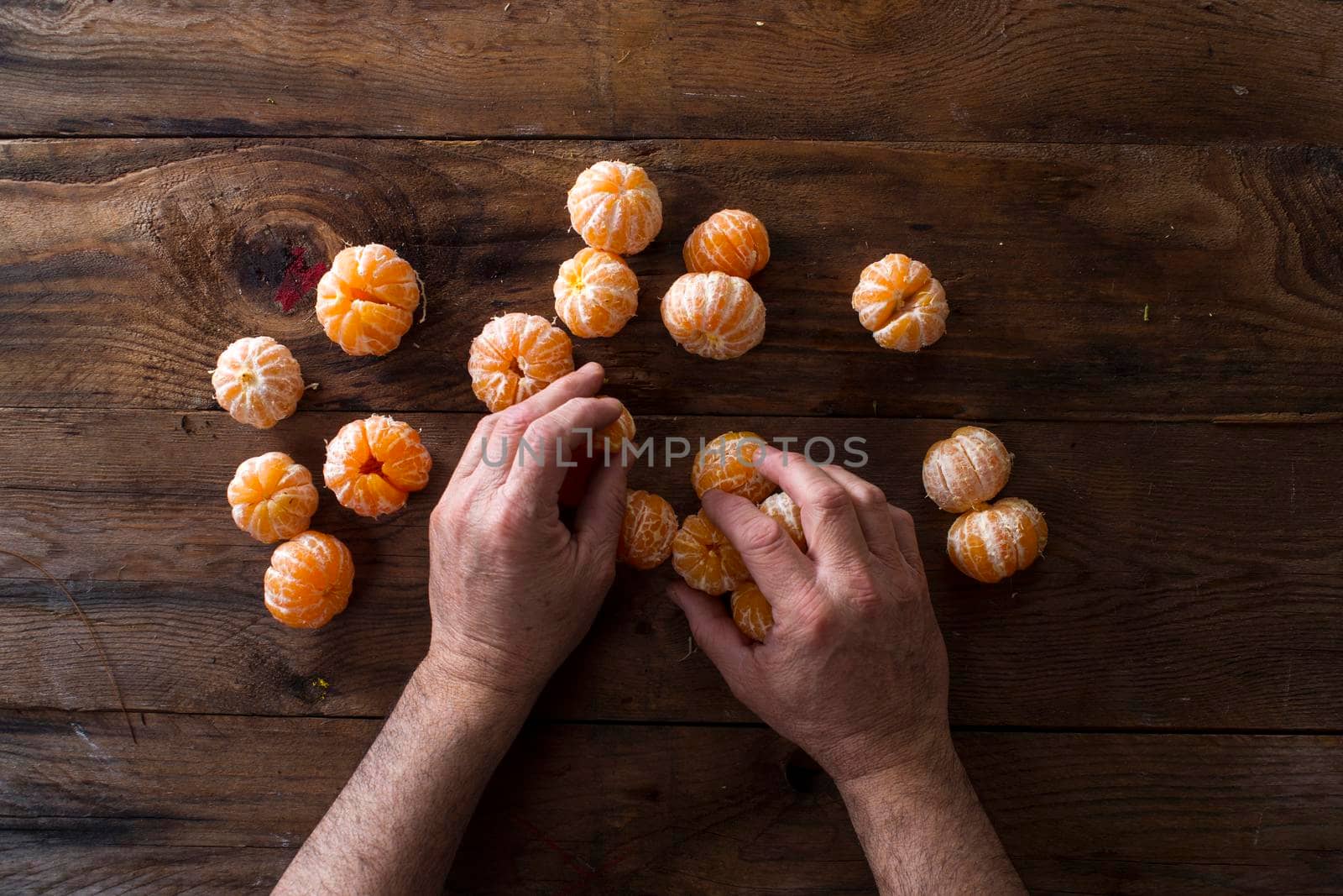 Presentation of Small peeled mandarin oranges on old wooden table