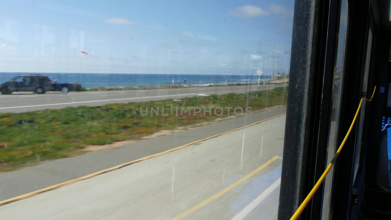 Bus window, pacific coast highway, freeway 101, California USA. Road trip along summer ocean or sea. by DogoraSun