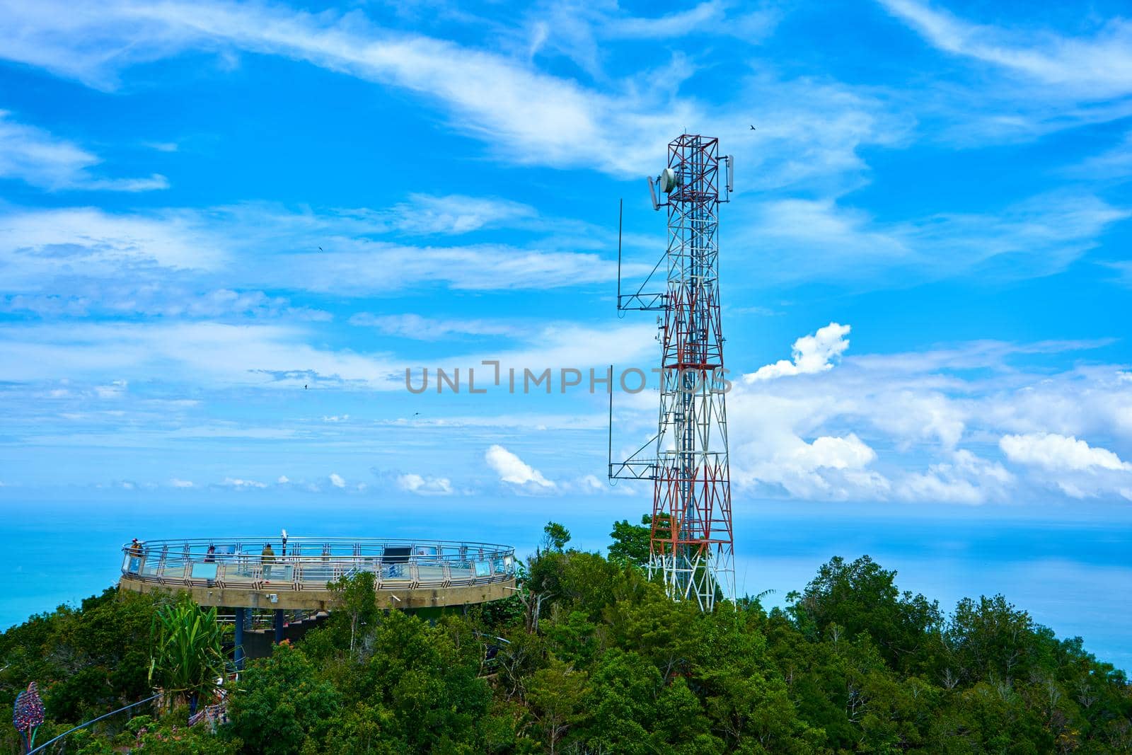 Radio communication tower on a background of blue sky.
