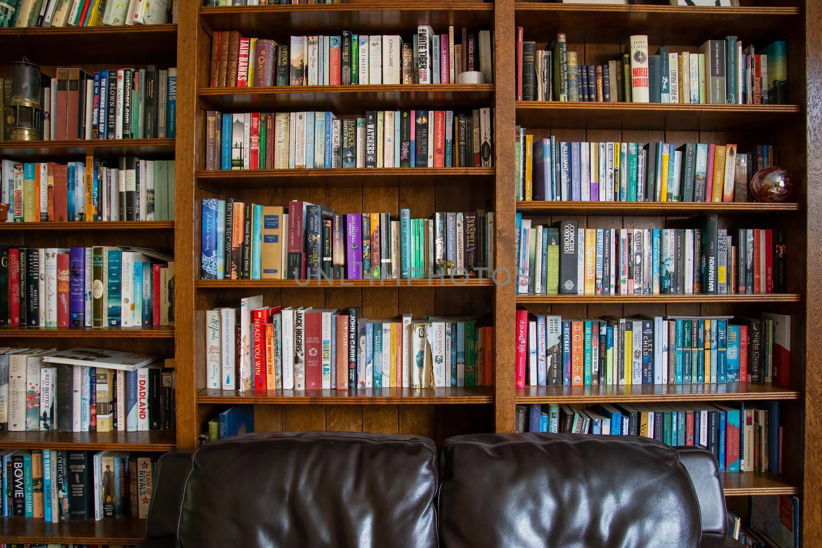 East Sussex, England - August 09 2020: Wooden bookcase filled with books in a UK home setting