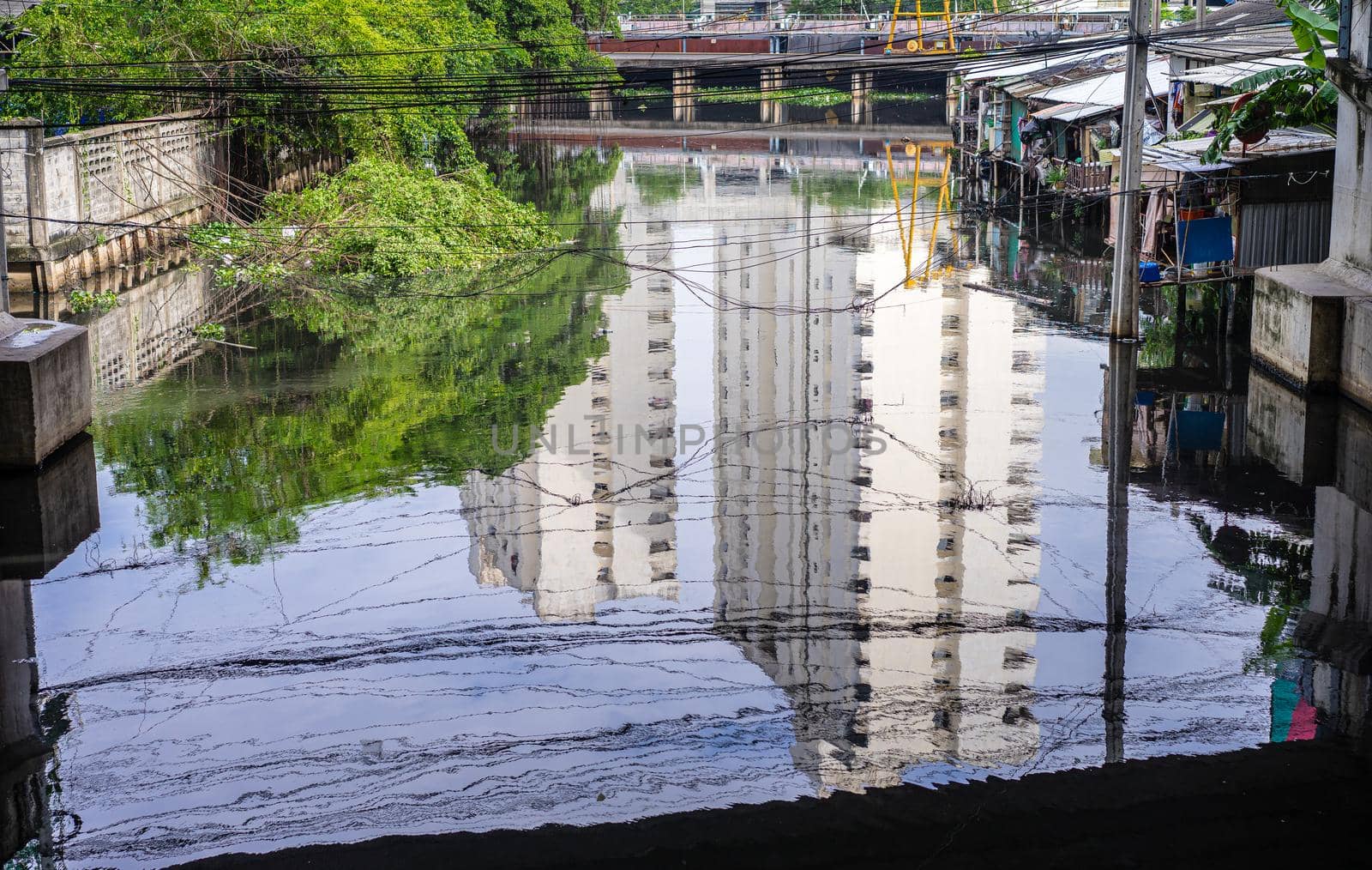 Reflection of building on the river and riverside home community by domonite