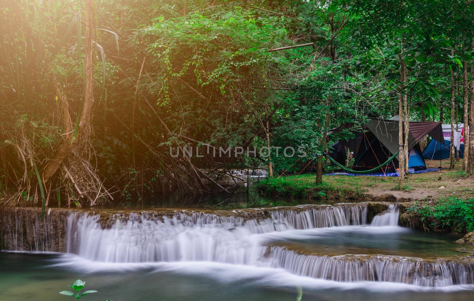 Camping and tent near waterfall  in nature park by domonite