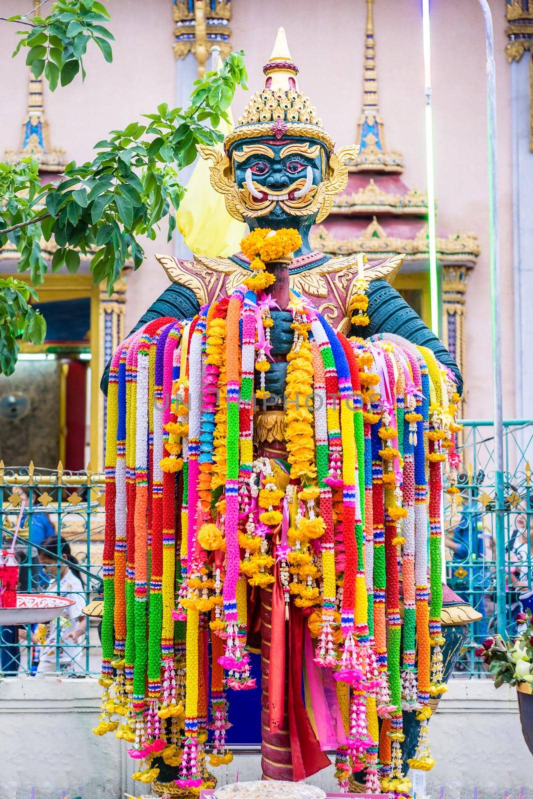 Giant statue hanging garland in the temple by domonite