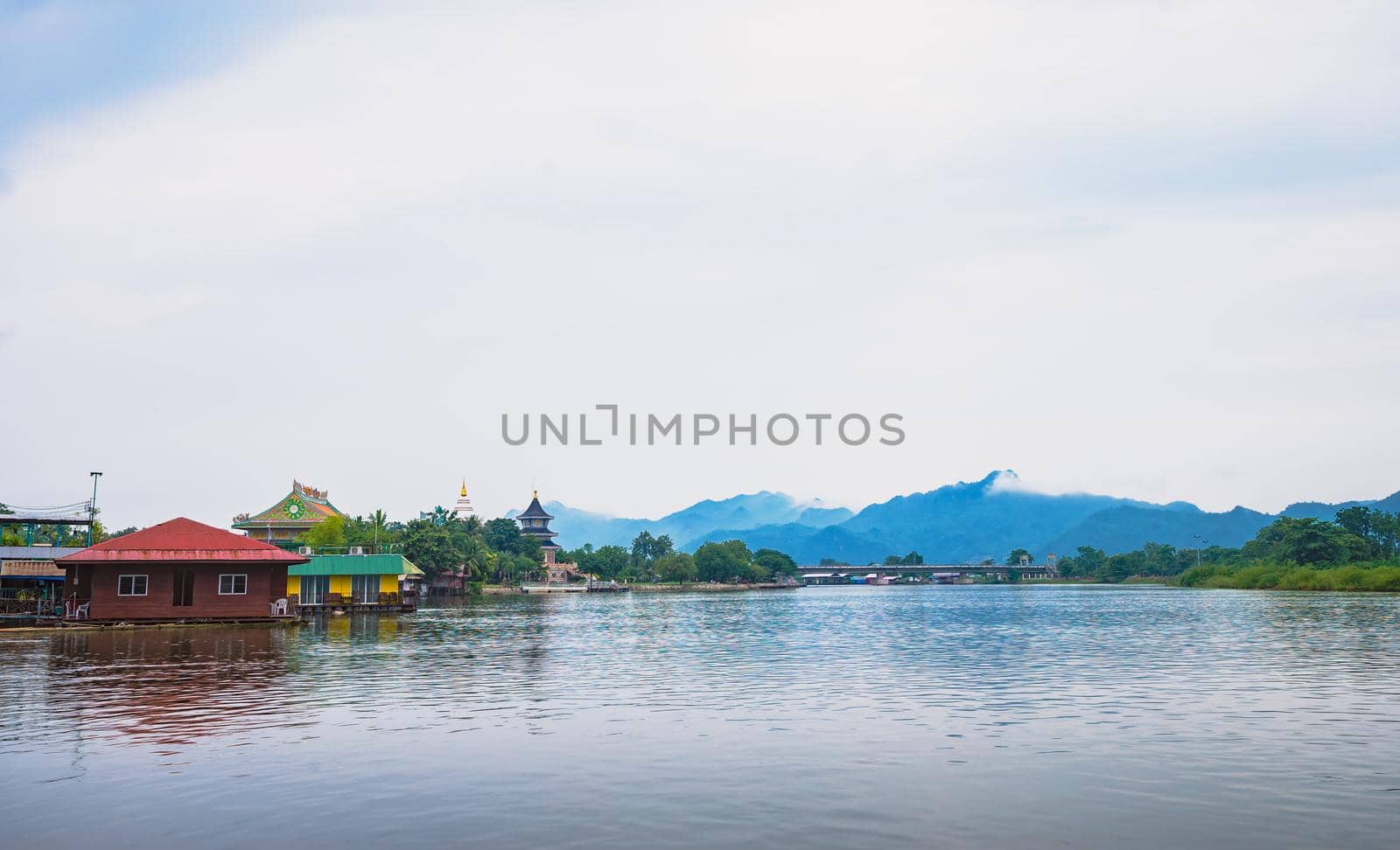 temple and community near the river with mountain background