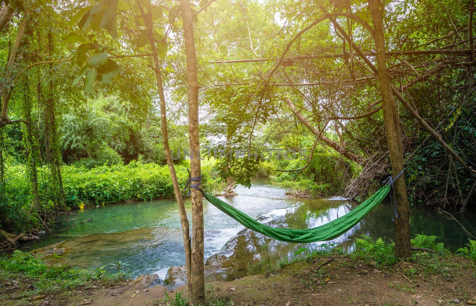 Hammock between two trees near the waterfall in campsite by domonite