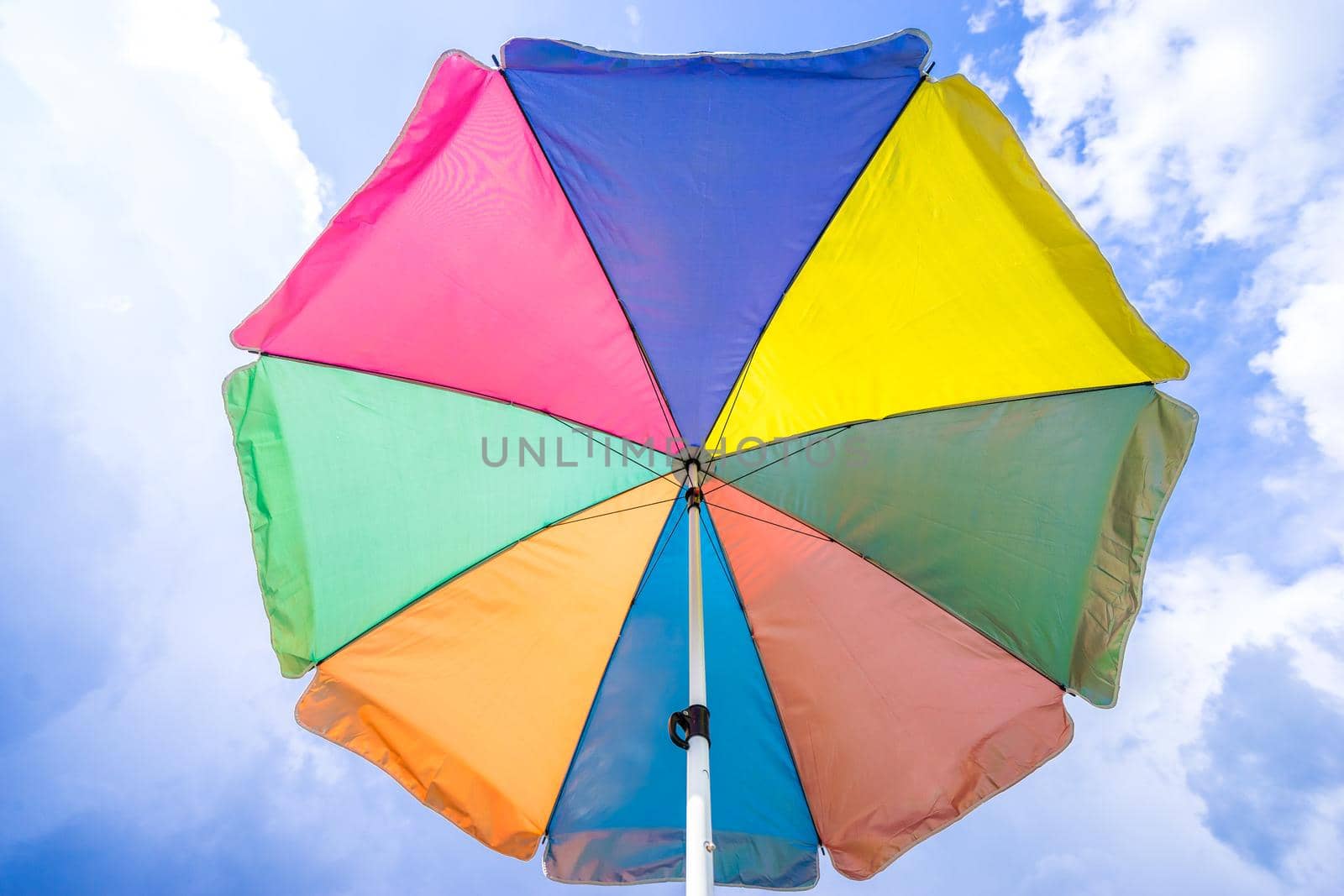 angle view of colorful umbrella under sunshine, summer season by domonite