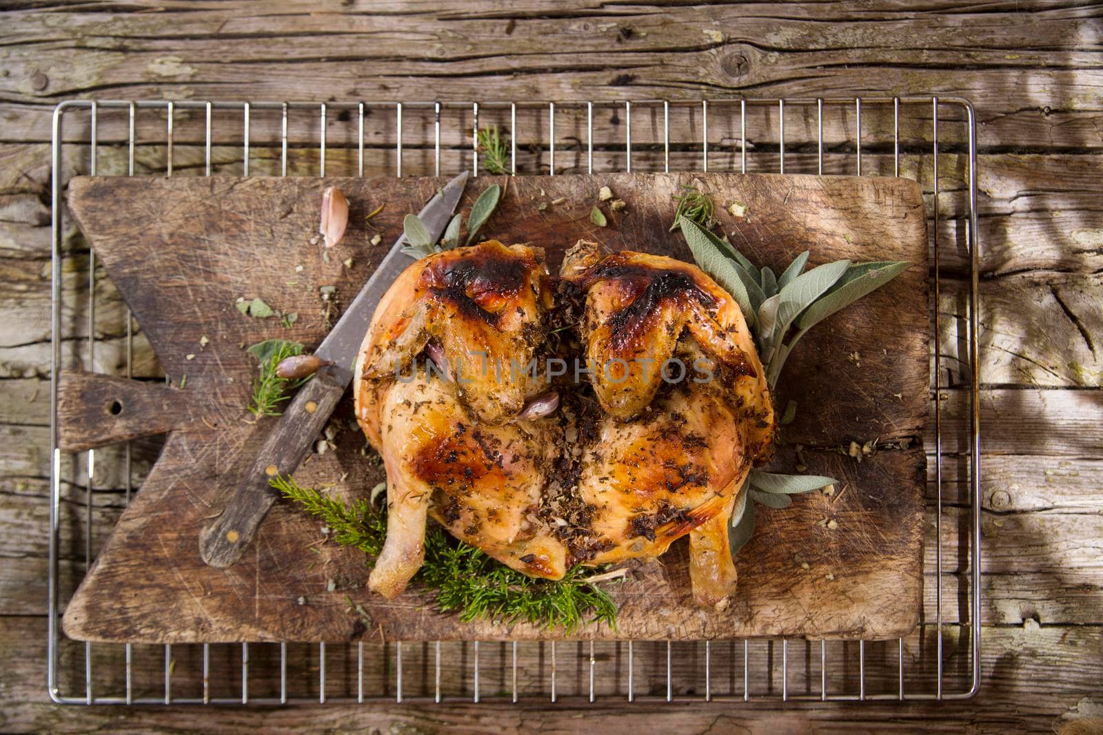 Presentation of a marinated chicken with herbs and baked in the oven