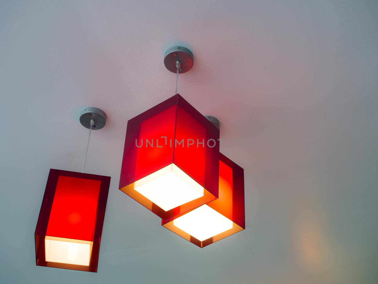 Three red hanging lights in an apartment
