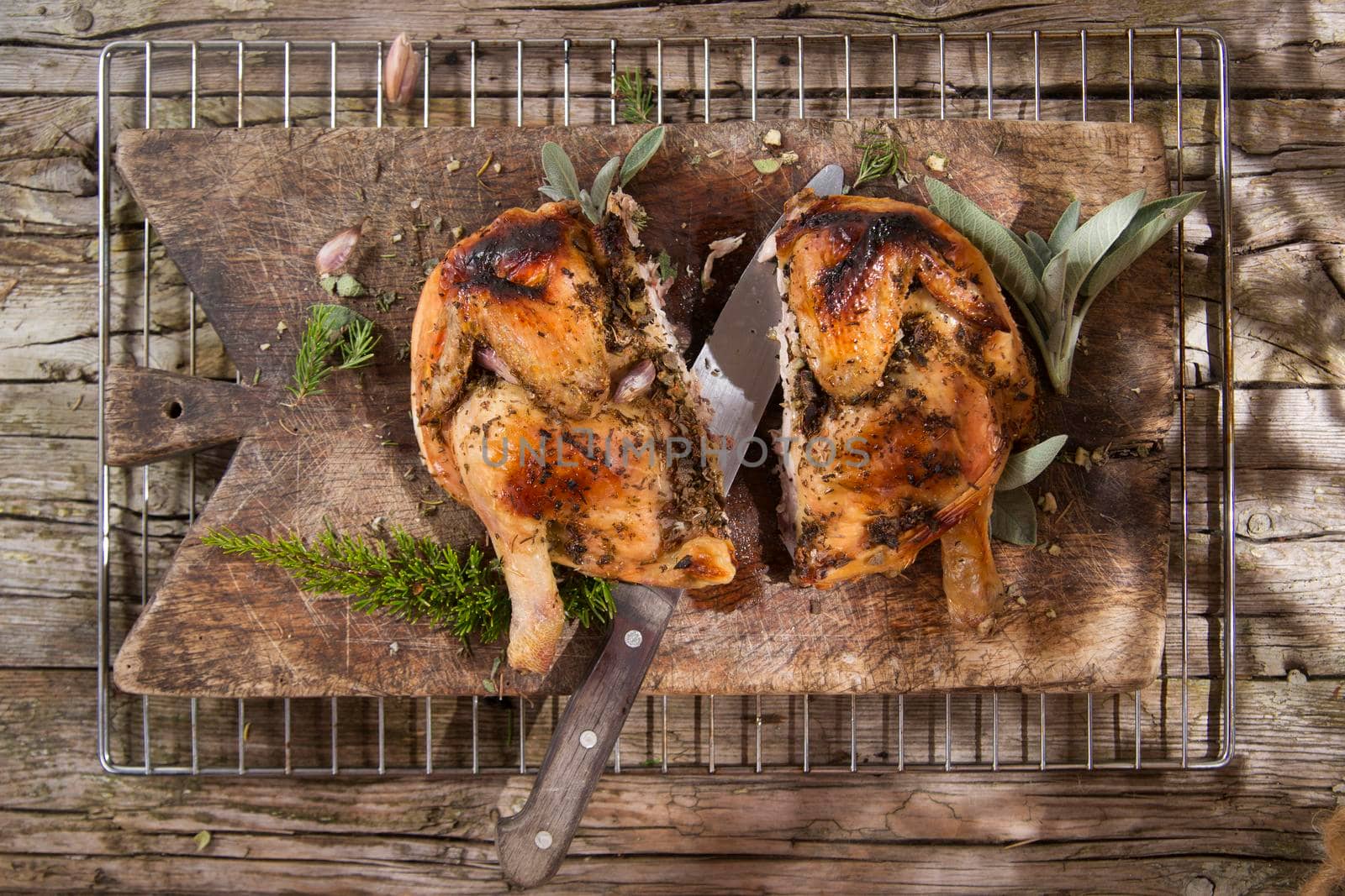 Presentation of a marinated chicken with herbs and baked in the oven