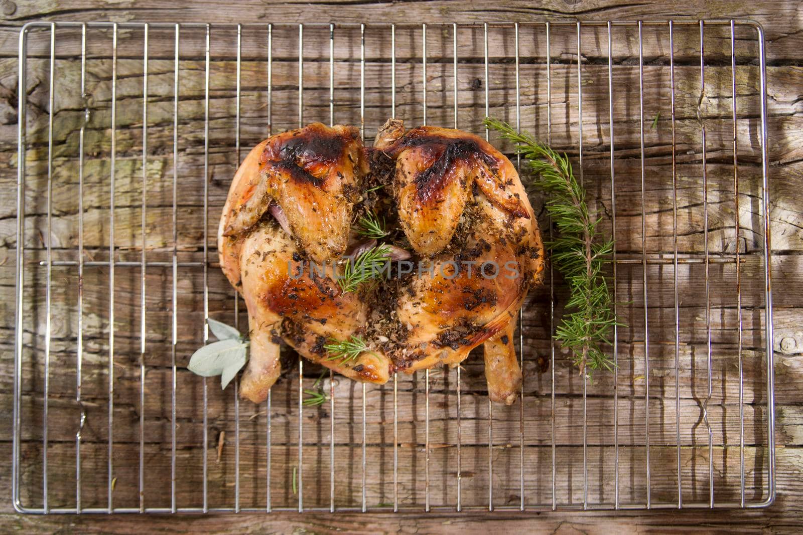 Presentation of a marinated chicken with herbs and baked in the oven