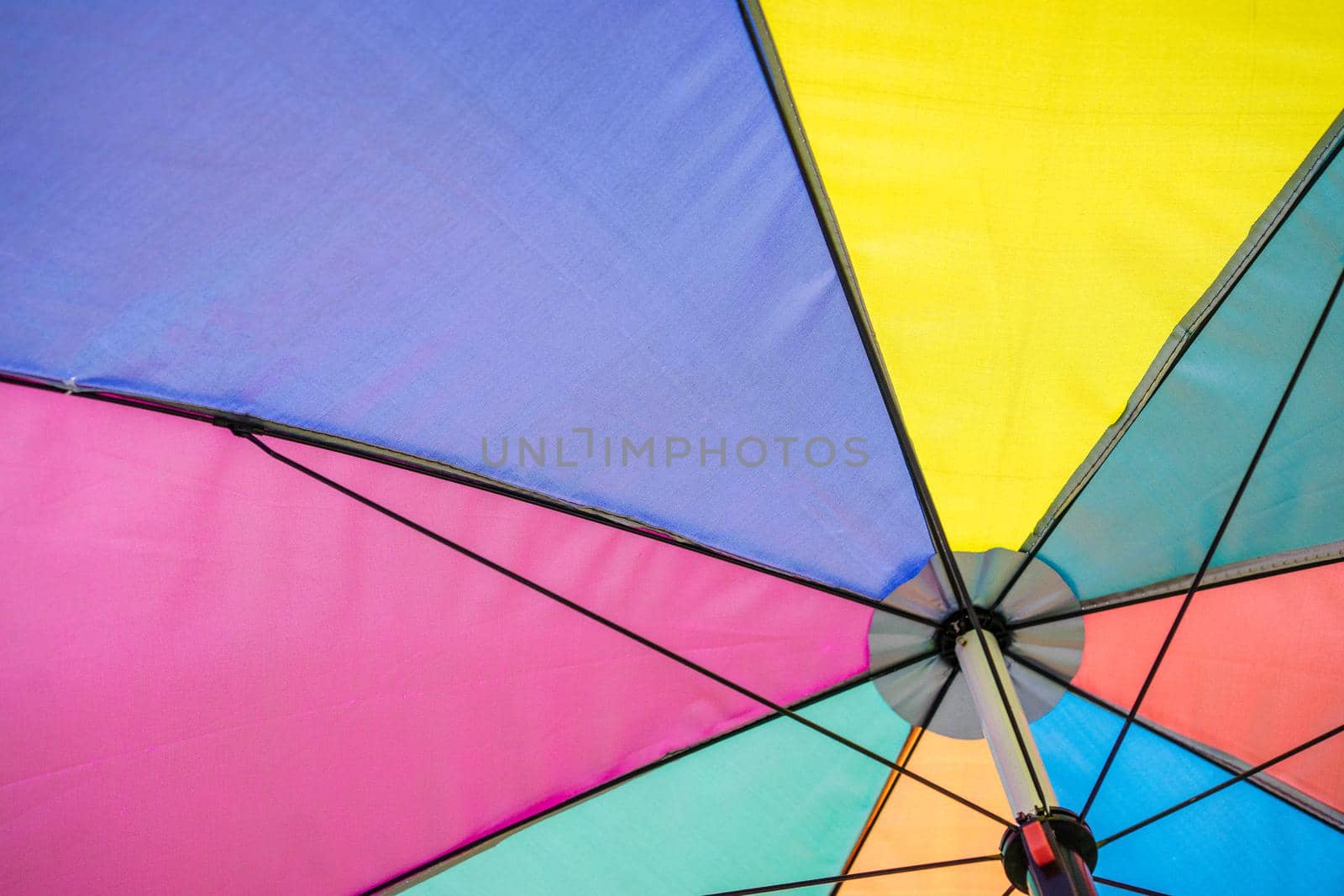 angle view of colorful umbrella under sunshine, summer season by domonite