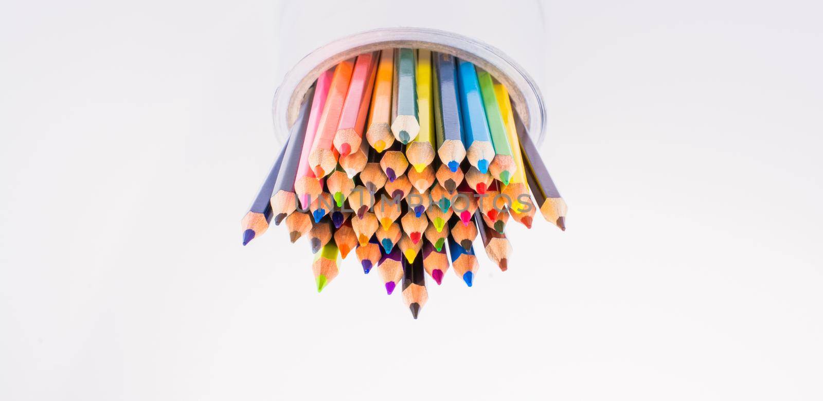 colorful pencils in a vase on a white background