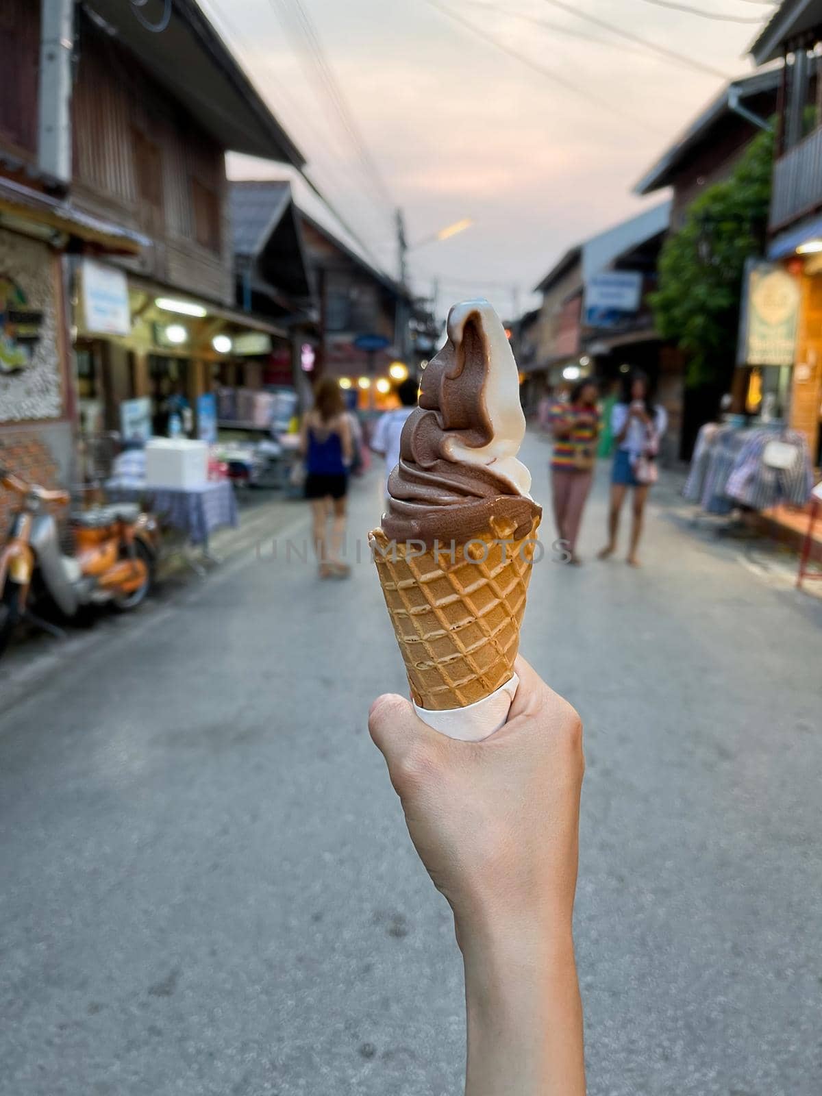Female hand holding chocolate ice cream
