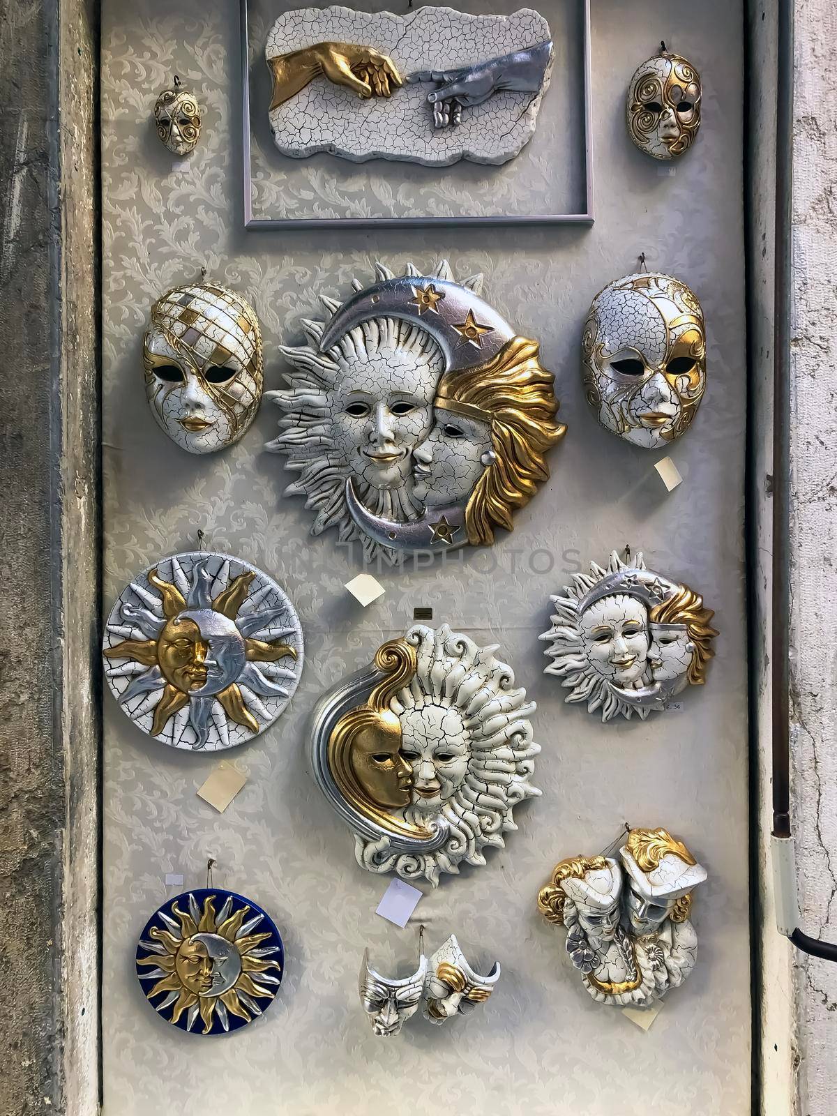 Venetian carnival masks in the wall of a shop in Venice, Veneto, Italy. High quality photo