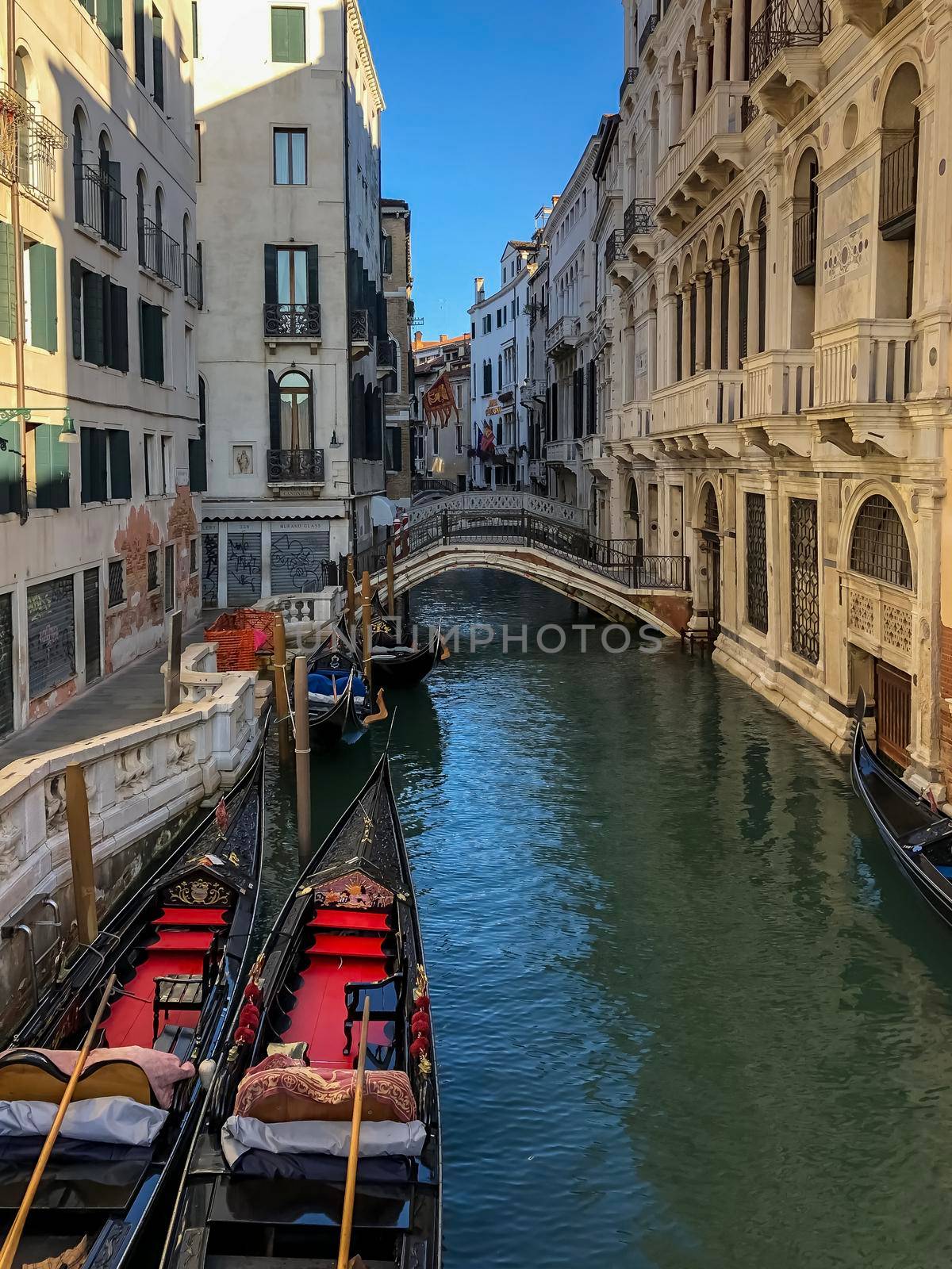 venetian canal and old brick houses in Venice, Italy by kaliaevaen