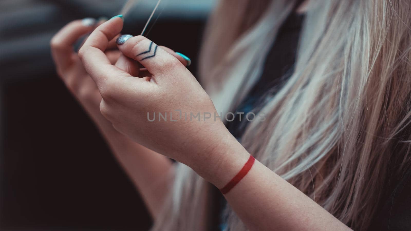 Womens hands with Arrows on the fingers, red line on the wrist - tattoos. Hipster style