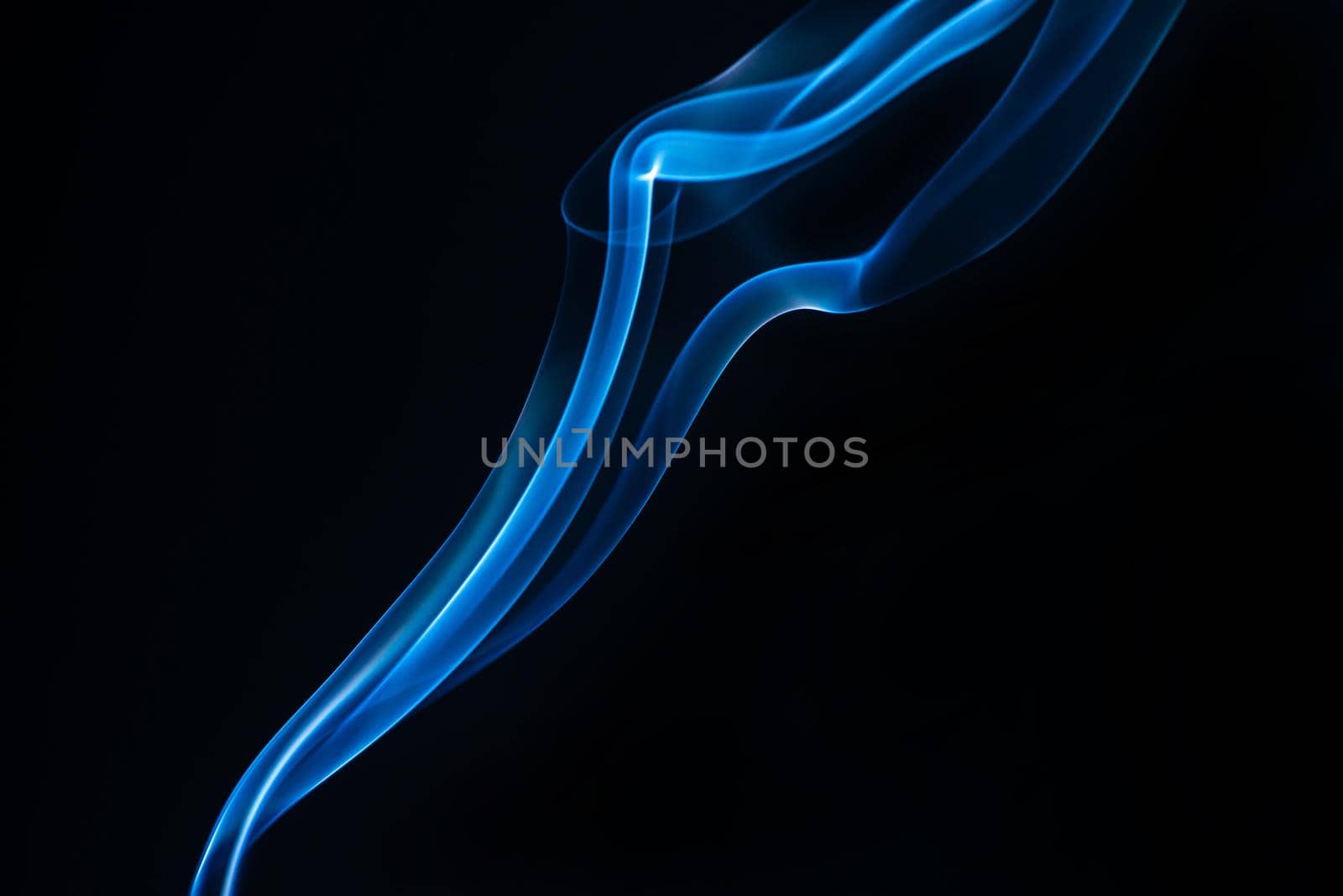 Blue smoke isolated on black background. by thanumporn