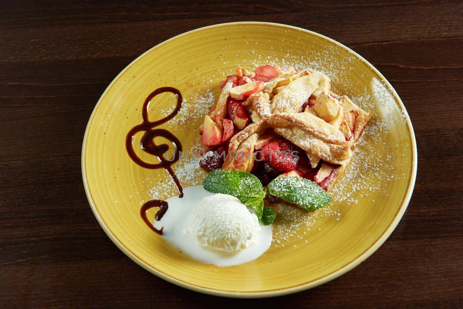 Melody of taste. Top view of a freshly baked fruit strudel served with ice cream