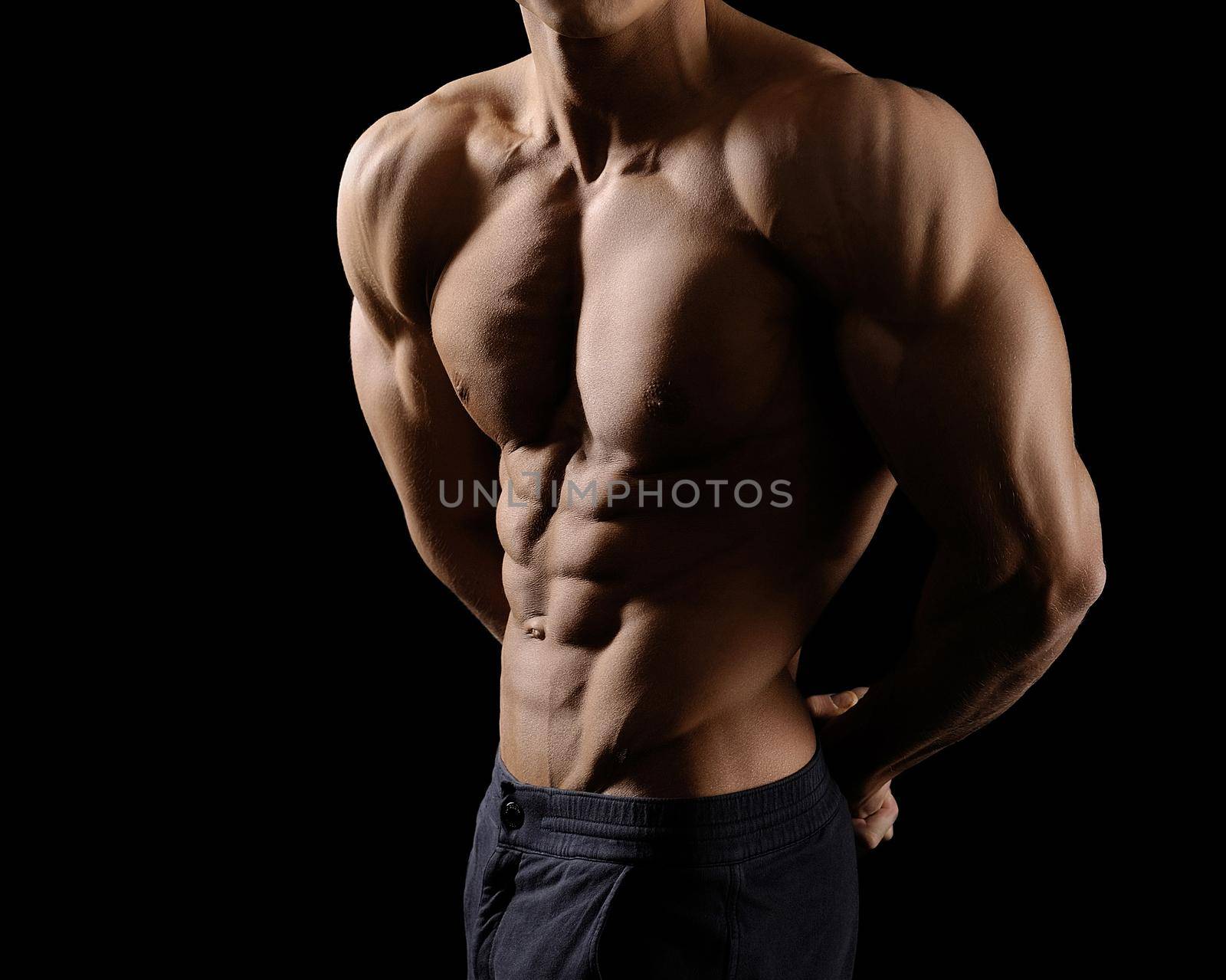 He lives with sports. Cropped shot of a male bodybuilder showing off his ripped abs posing shirtless in studio
