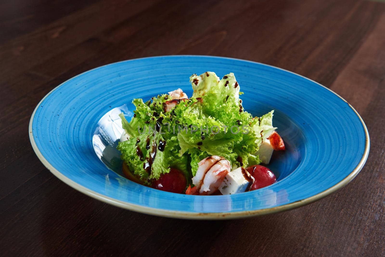 Delicious shrimp salad served on a blue plate by SerhiiBobyk