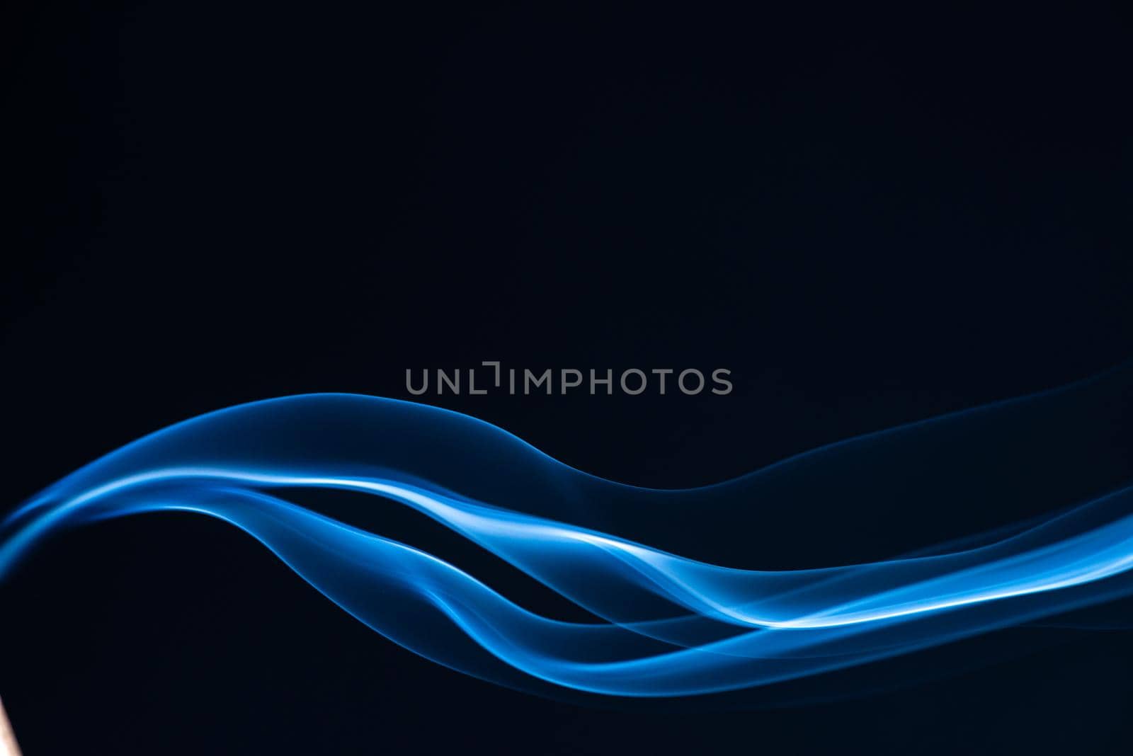 Blue smoke isolated on black background.