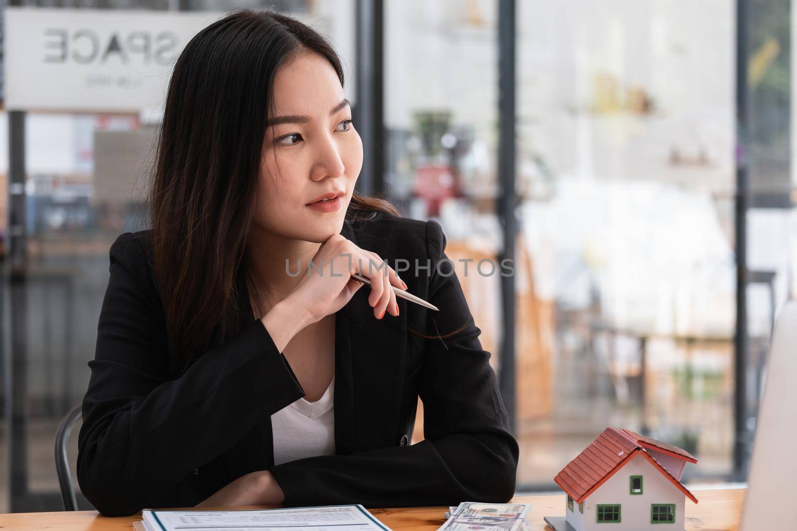A stressed woman signs a contract to cancel her rent apartment and pay an outstanding payment by itchaznong