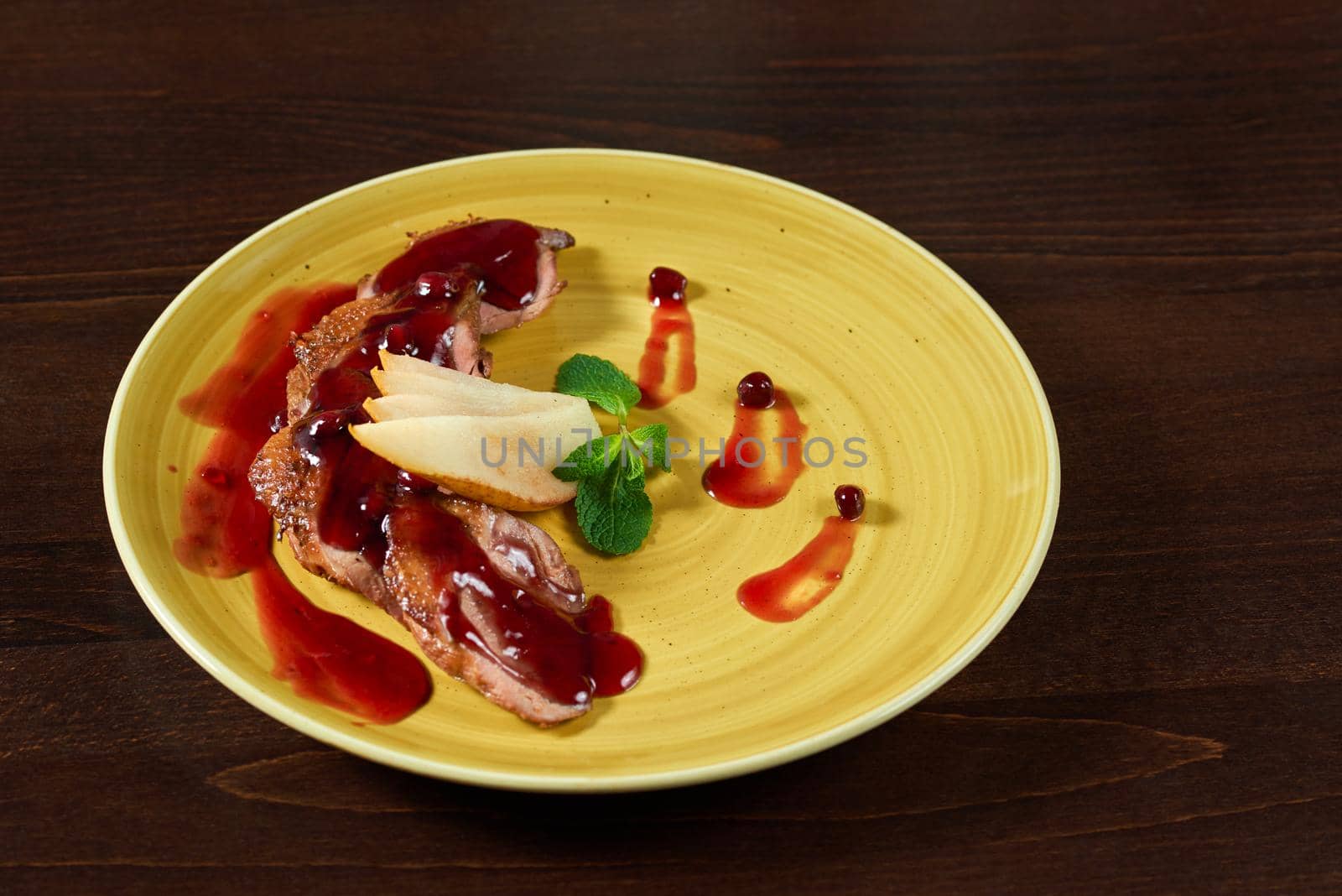 Roasted duck meat slices with peard and cranberries sauce by SerhiiBobyk