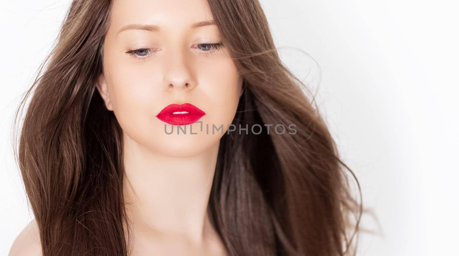 Beautiful woman with healthy gorgeous long hair, natural brunette hairstyle and red lipstick makeup, haircare and beauty ad.