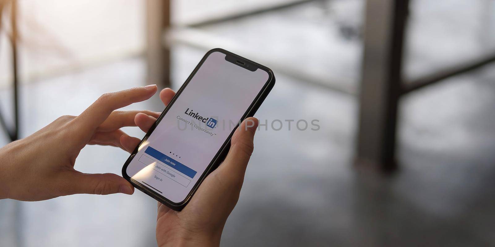 CHIANG MAI, THAILAND, DEC 12, 2020 : A women holds Apple iPhone Xs with LinkedIn application on the screen.LinkedIn is a photo-sharing app for smartphones. by wichayada