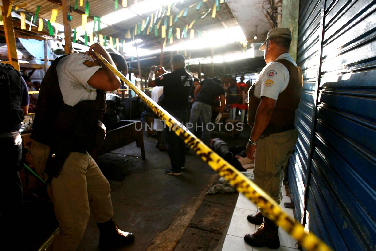 salvador, bahia, brazil - march 24, 2015: Investigators from the homicide department and experts carry out the cadaveric survey on a man murdered by knife blows in the city of Salvador.