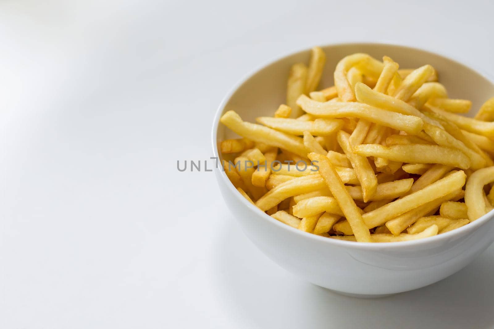 Bowl of french fries on a white background by magicbones