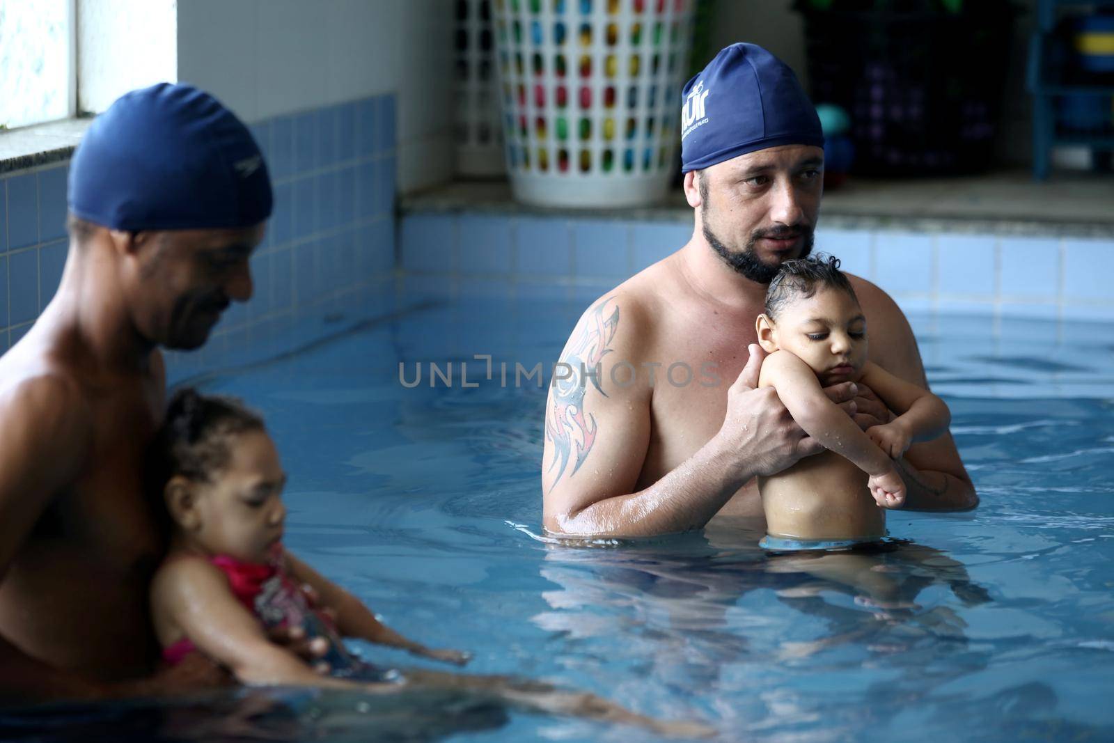 lauro de freitas, bahia, brazil - september 29, 2017: Children with microcephaly during swimming lesson at a club in the city of Lauro de Freitas. The deformity was adequate due to the zica virus.