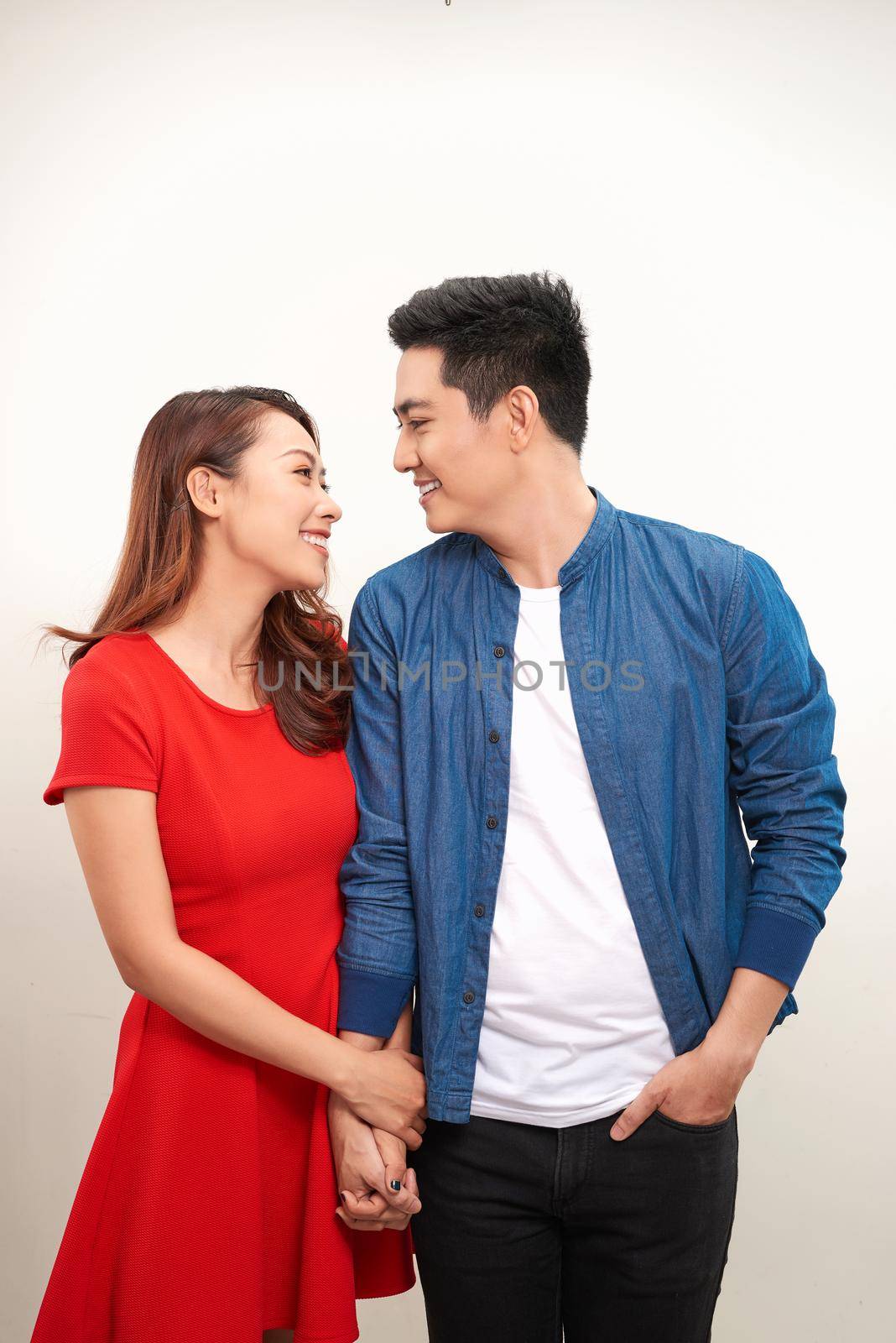 Young nice couple posing in the studio, express emotions and gestures, smiling