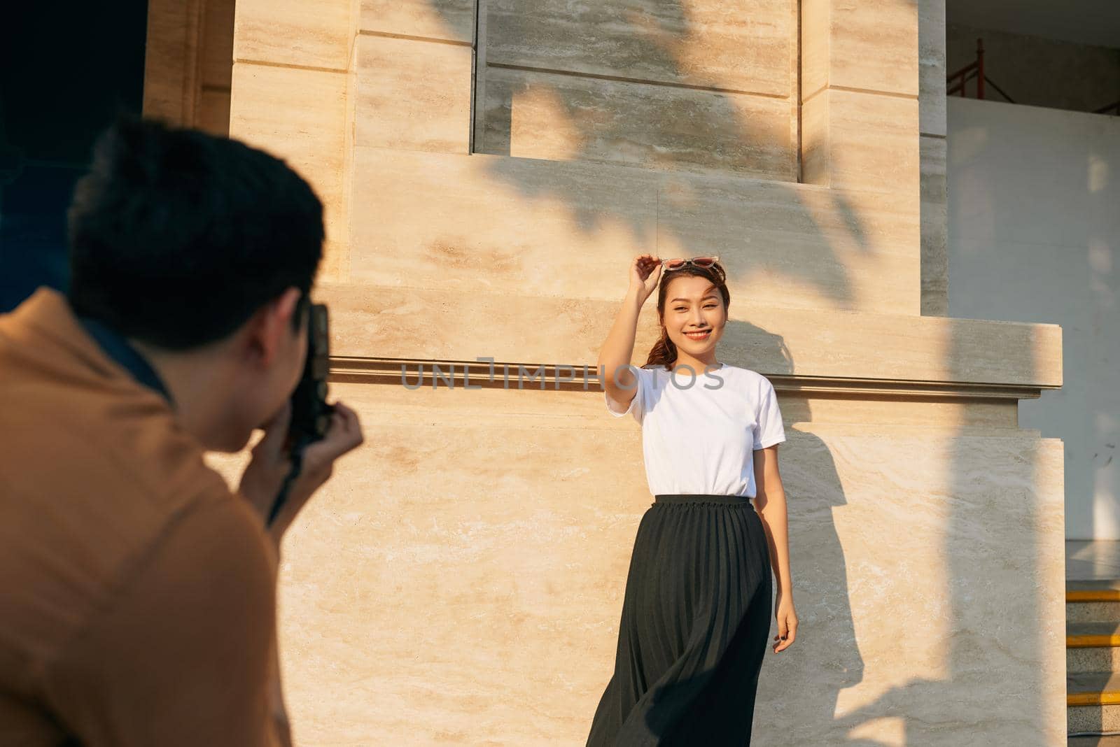 summer holidays and dating concept - couple taking photo picture in the city 