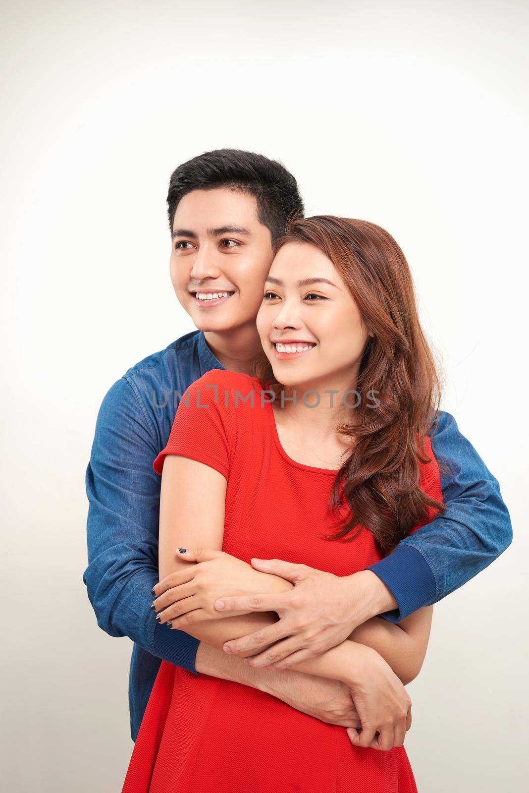 happy young love couple standing hugged white background