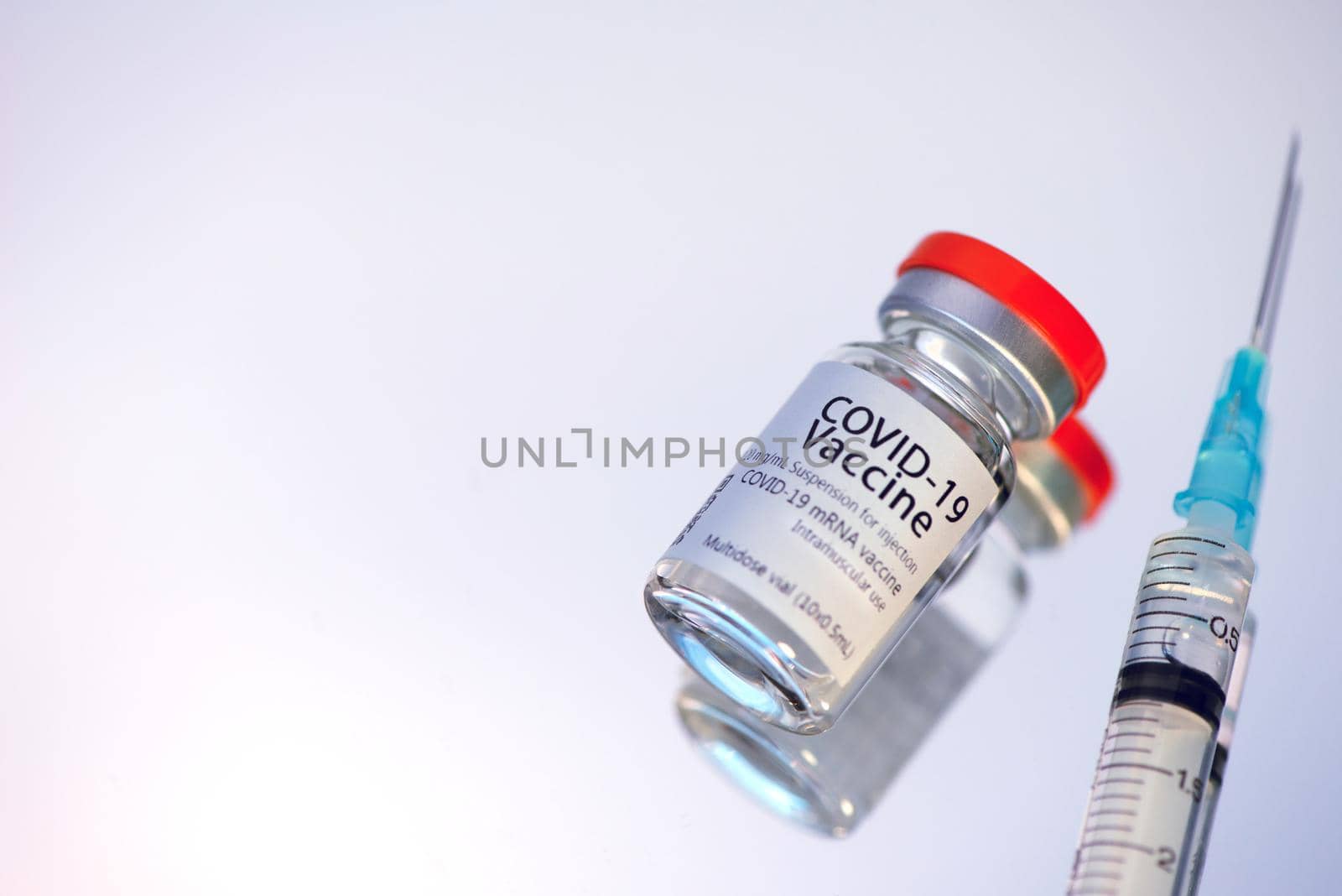 Ampoules with COVID-19 coronavirus vaccine, with a syringe for vaccination. Healthcare And Medical concept. by thanumporn