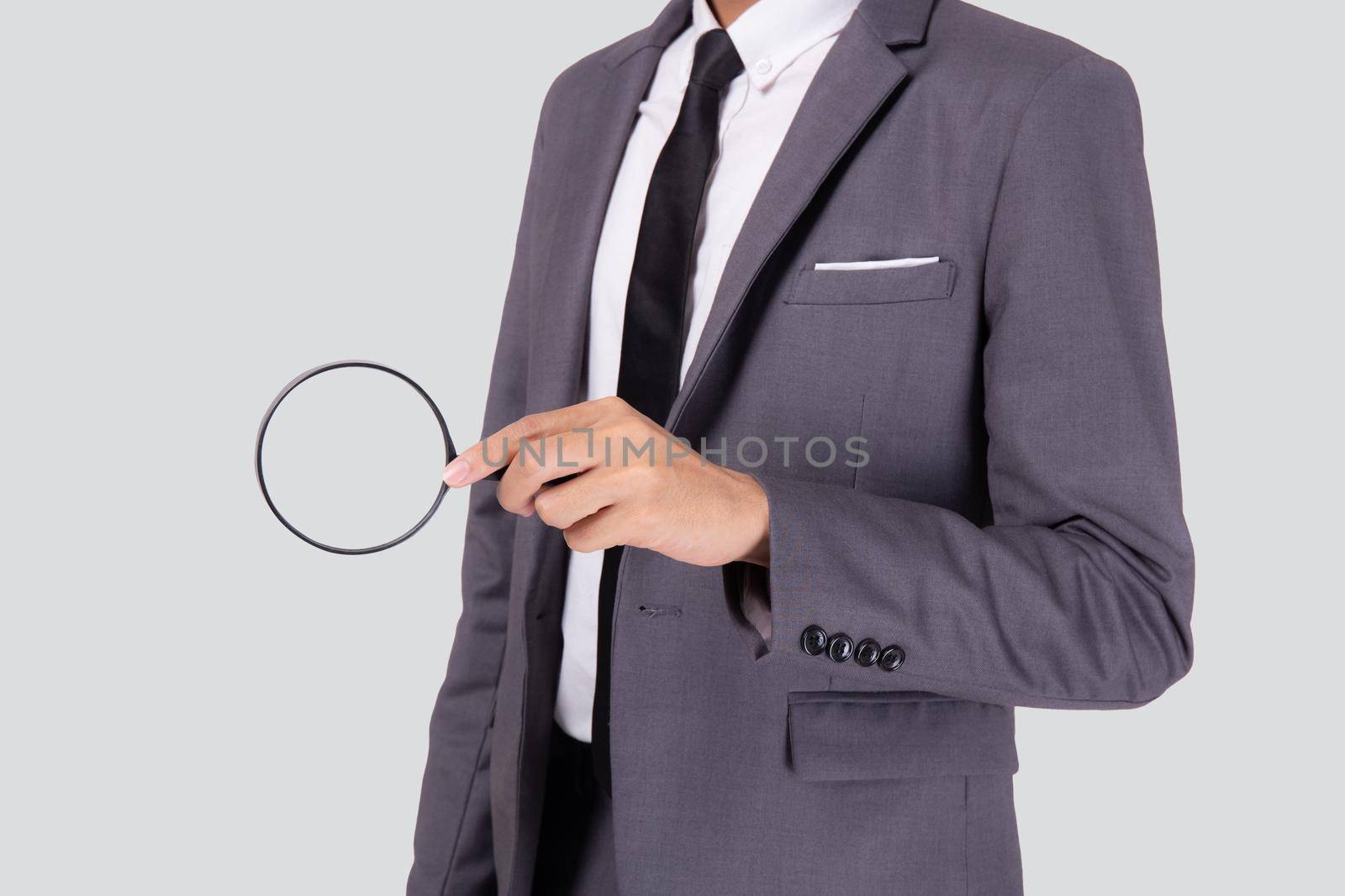 Closeup young asian business man in suit look magnifying glass for search isolated on white background, businessman expression and find quality, inspector and scrutiny, male expression.