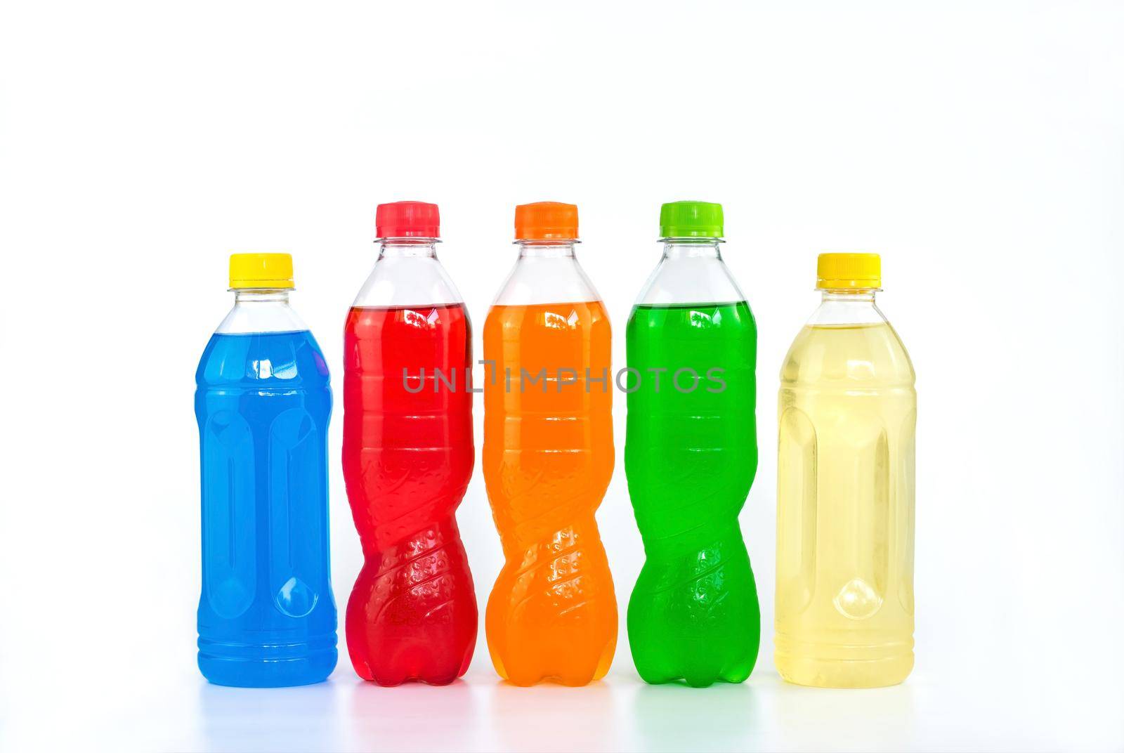 Multi colored drinks in plastic bottles on white background. by wattanaphob