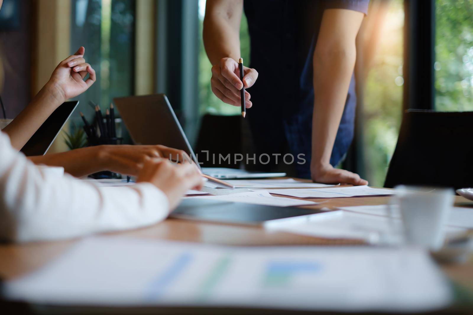 Business team discussing together during meeting at office. Colleagues workshopping business ideas. Brainstorm and ideas Concept. by itchaznong